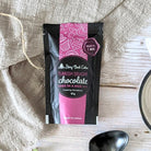 A mug of Turkish Delight Cake mix, ready to bake, on a wooden surface