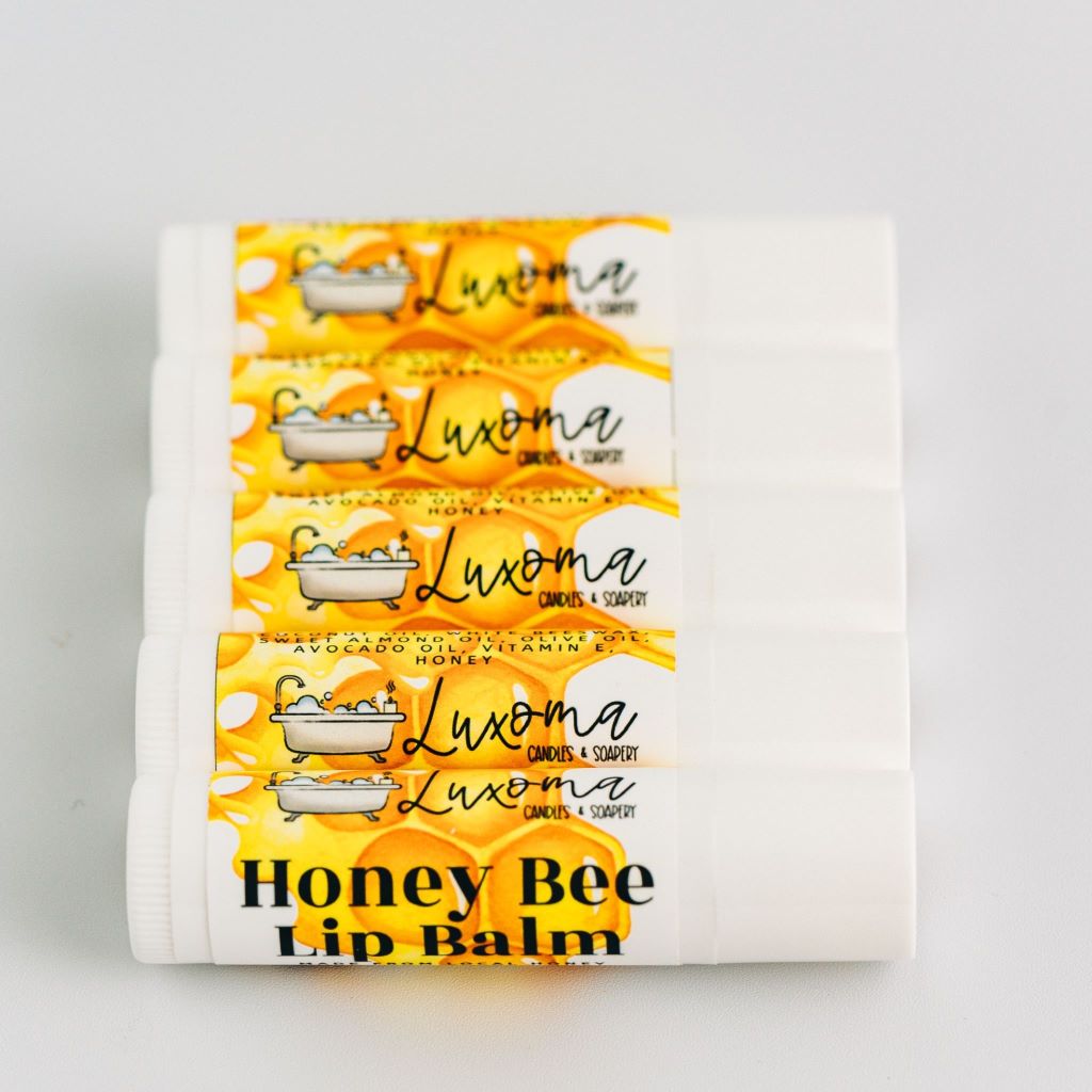 5 honey lip balms on bench