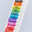 10 Flavoured lip balms on a bench