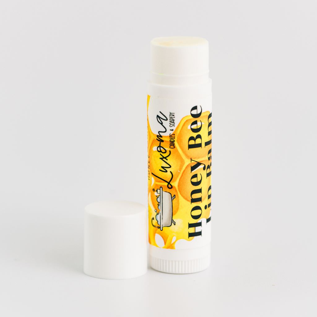 Single honey lip balm on white background